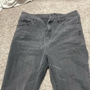 Plain black high waisted jeans with ruffles/rips at the bottom of the pants